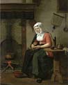 woman seated in a kitchen peeling apple